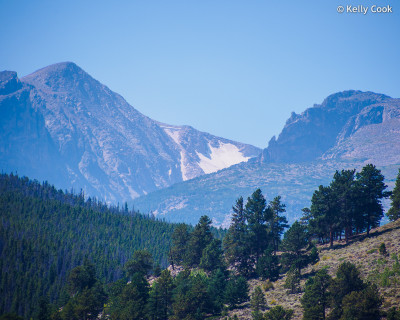 This is a telephoto view of the distant peaks that you can just make out from Hollowell Park. Left is Hallett Peak, the snowy patch in the middle is Tyndall Glacier, right is Flattop Mountain.